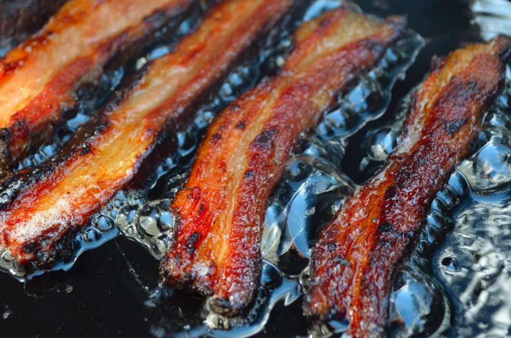 Here is some thick cut bacon frying on the same grill it was smoked on minutes before- a great example of the Primo's versatility.