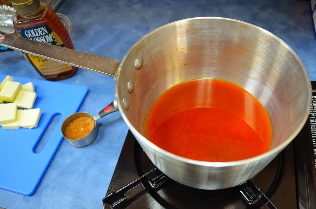 Heat the hot sauce until it just begins to boil then reduce heat to low.