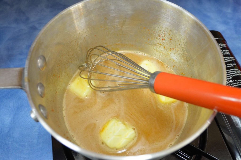 Add the butter a couple pieces at a time. Whisk constantly and don't let it boil.  Once all the butter is in, whisk in the rub and then the honey.