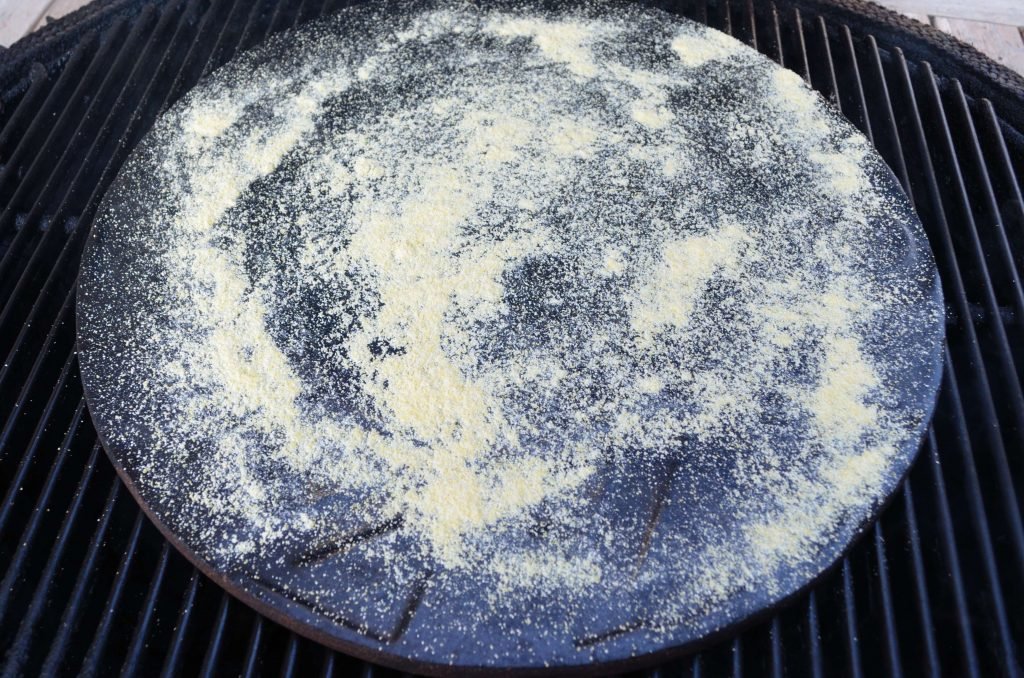 Give your pizza stone a healthy sprinkle of cornmeal right before you put on the pizza.