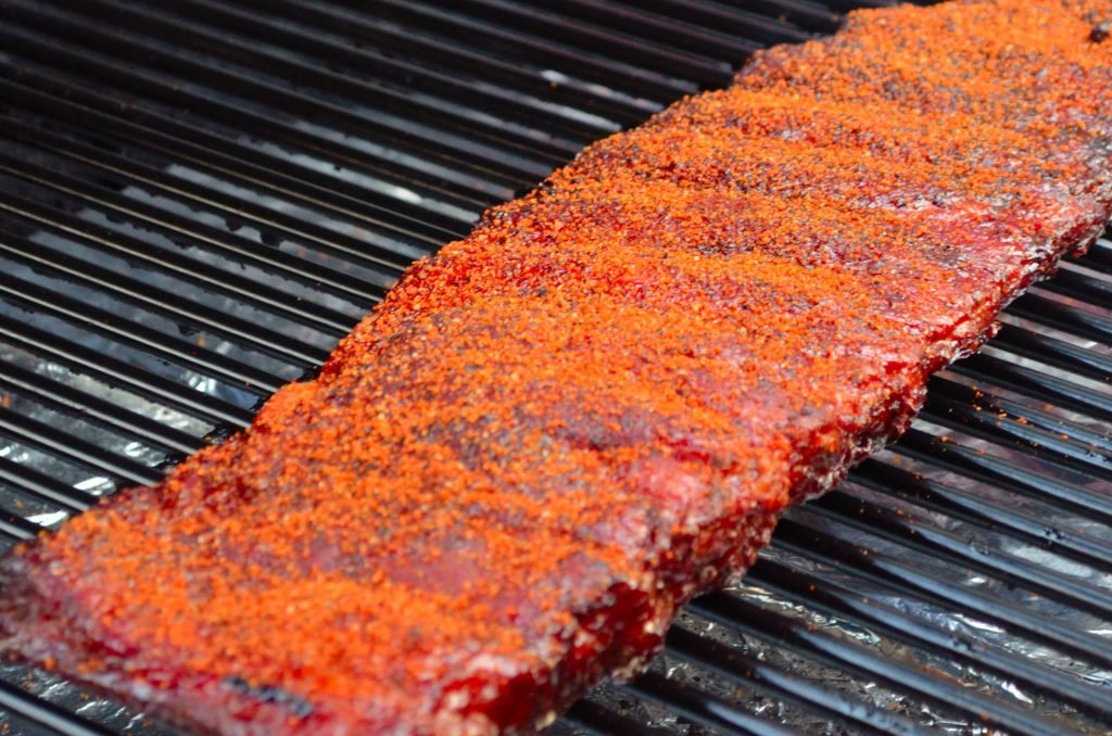 At this point you can keep the ribs wrapped in foil and towel in a cooler until you are ready to serve. (They will stay hot for hours!)  When you are ready to serve, put them back on the Primo and give them another healthy sprinkle of rub.