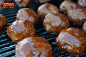 Glazed and smoked BBQ meatballs on the grill