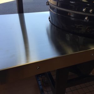 Stainless steel side shelves on a Primo Grill