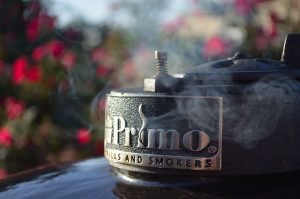 Smoke coming out of the top of a Primo Grill