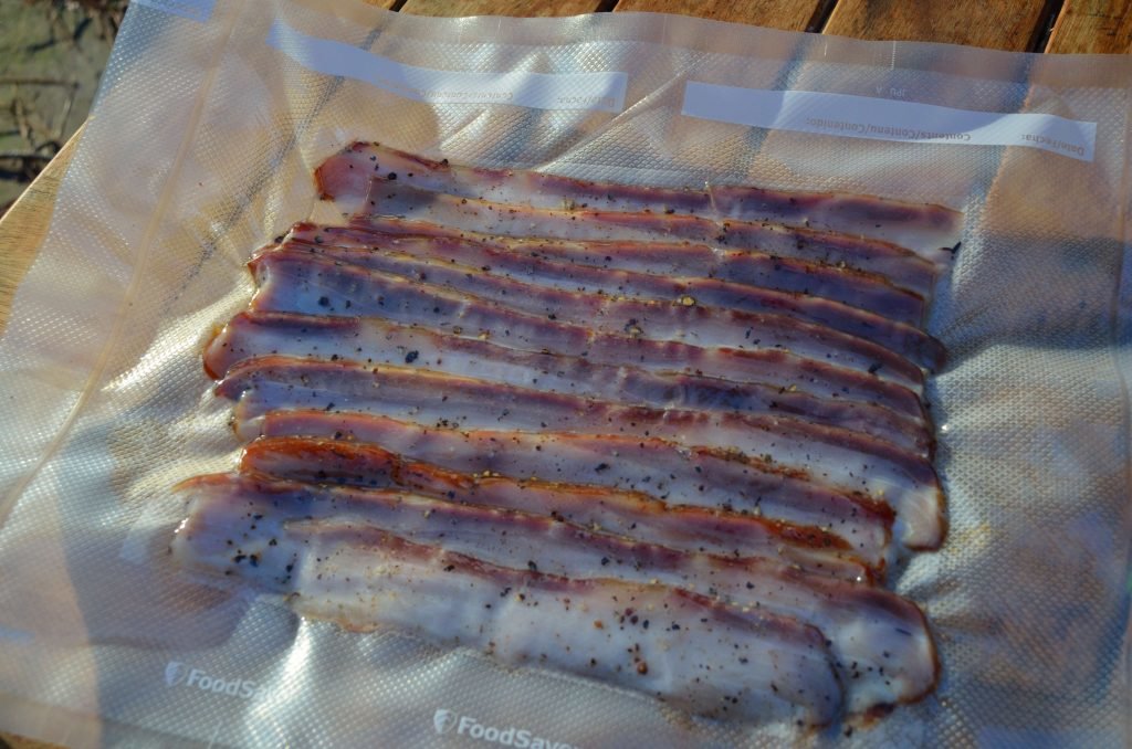 A "foodsaver" is another helpful tool to package the bacon.  Here we cracked some pepper on it before it was sealed.  Your friends won't complain if you hand them one of these.