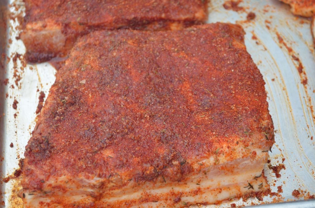 Brine the belly overnight (1/2 cup of salt to gallon of water). Prepare the Primo for smoking. Rub the belly well.