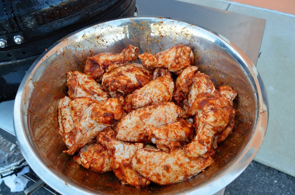 When ready, prepare the Primo to smoke. Soak a cup or two of applewood chips. Rub the wings well- 