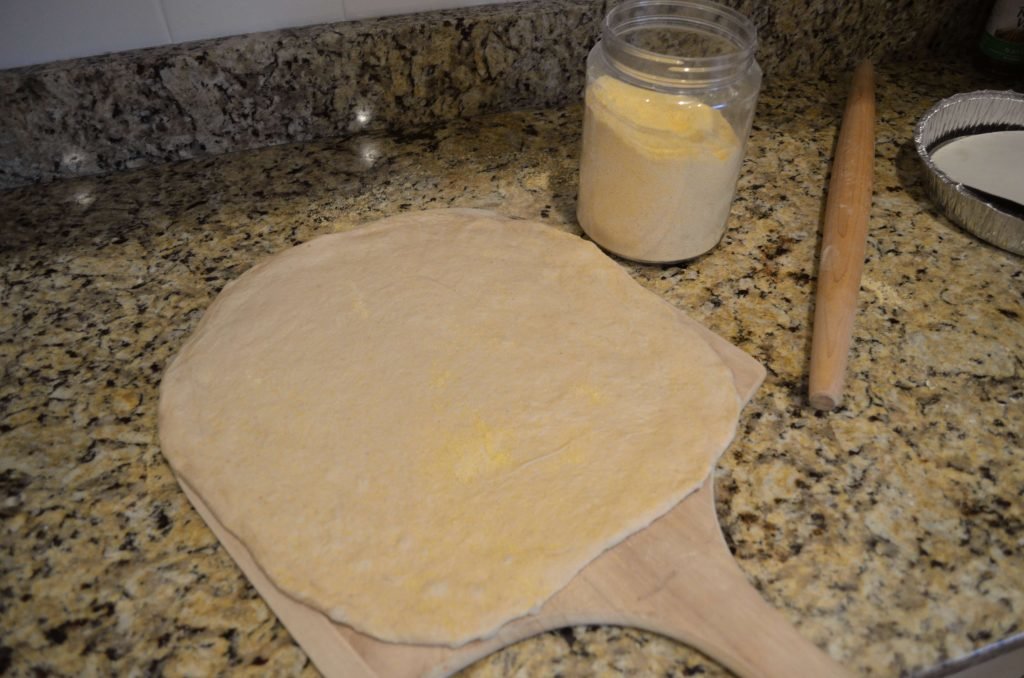 Roll out dough on floured surface and place on cornmeal coated pizza peel.