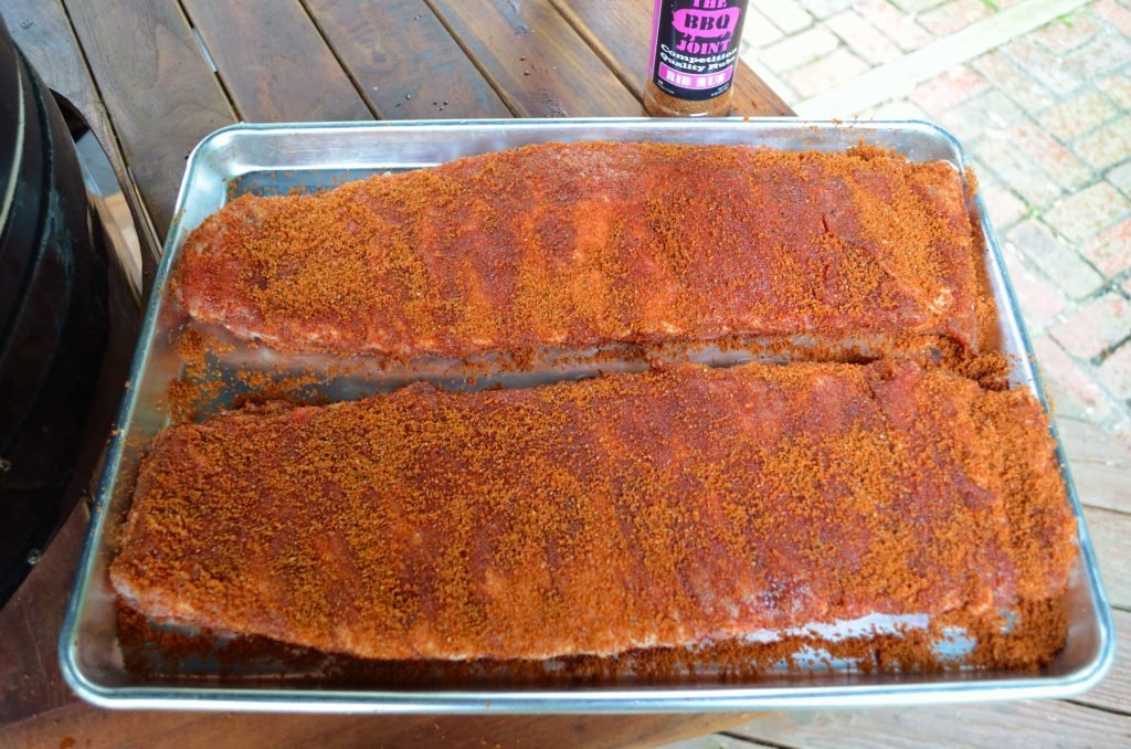You will want to rub your ribs well- here we are using Rib Rub from the BBQ Joint. 