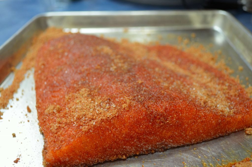 Rub the salmon well. For this size piece, we mixed together a 1/2 cup of brown sugar with a tablespoon each of kosher salt, smoked paprika, and garlic granules.