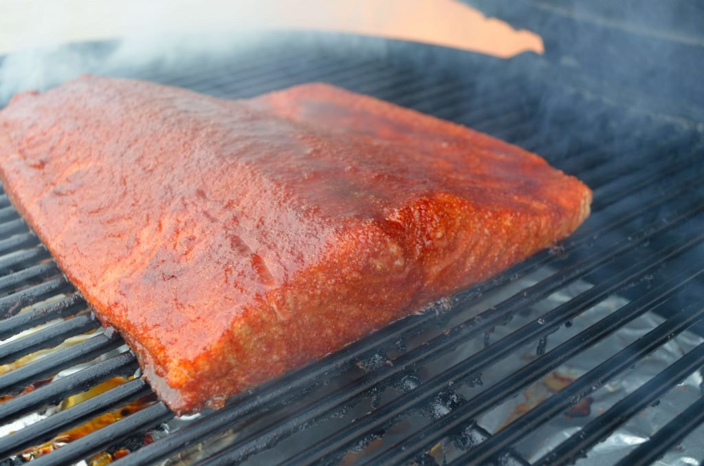 Smoke the salmon until the internal temp hits 150 or so. A thermopen thermometer is a very helpful tool here. Also, we would recommend rubbing a little olive oil on the skin side to help remove the fish when it's time.