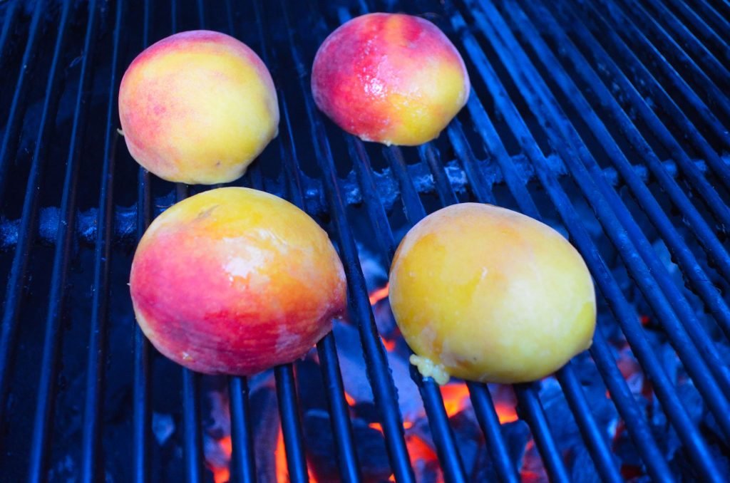 Grill the peaches over direct heat, cut side down first.  Depending on the intensity of the fire, turn over in 3 to 6 minutes.