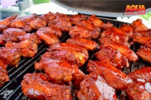 A set of chicken wings on a Primo grill being smoked