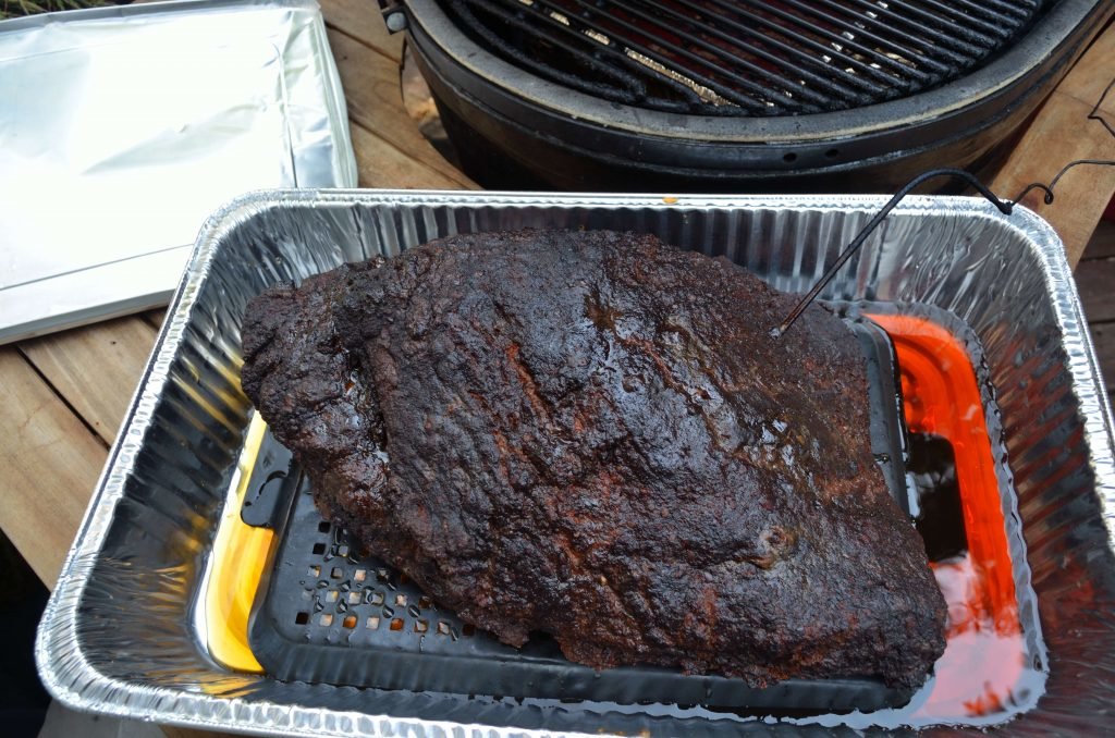 At this point you can choose to wrap the brisket in foil with some stock or even let it go on the grill.  However, we would recommend putting the brisket in a pan with some stock, taking care to elevate the brisket above the liquid. Cover the pan with foil and continue cooking until the flat is 195 to 200.