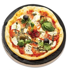 A pizza sitting on a glazed baking stone