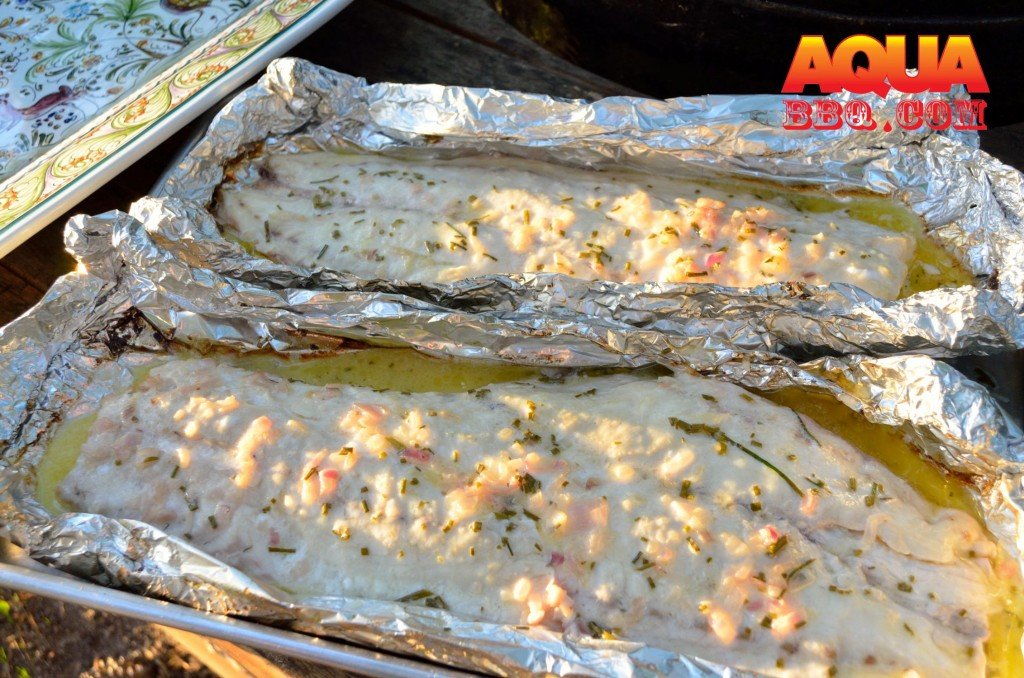 Cook the fish until the internal temp is around 140.  We would recommend carefully sliding the foil pans off the grill onto a sheet pan.