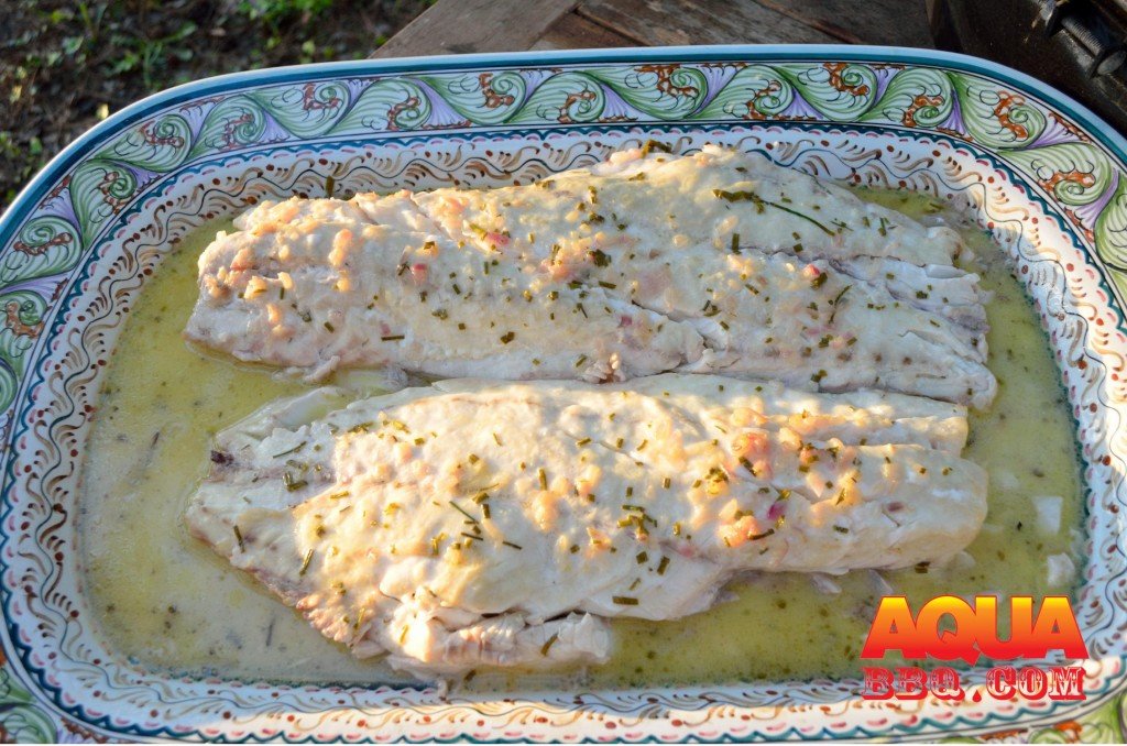 Carefully transfer the fish to a serving tray and pour the poaching liquid over the fish.  Enjoy!