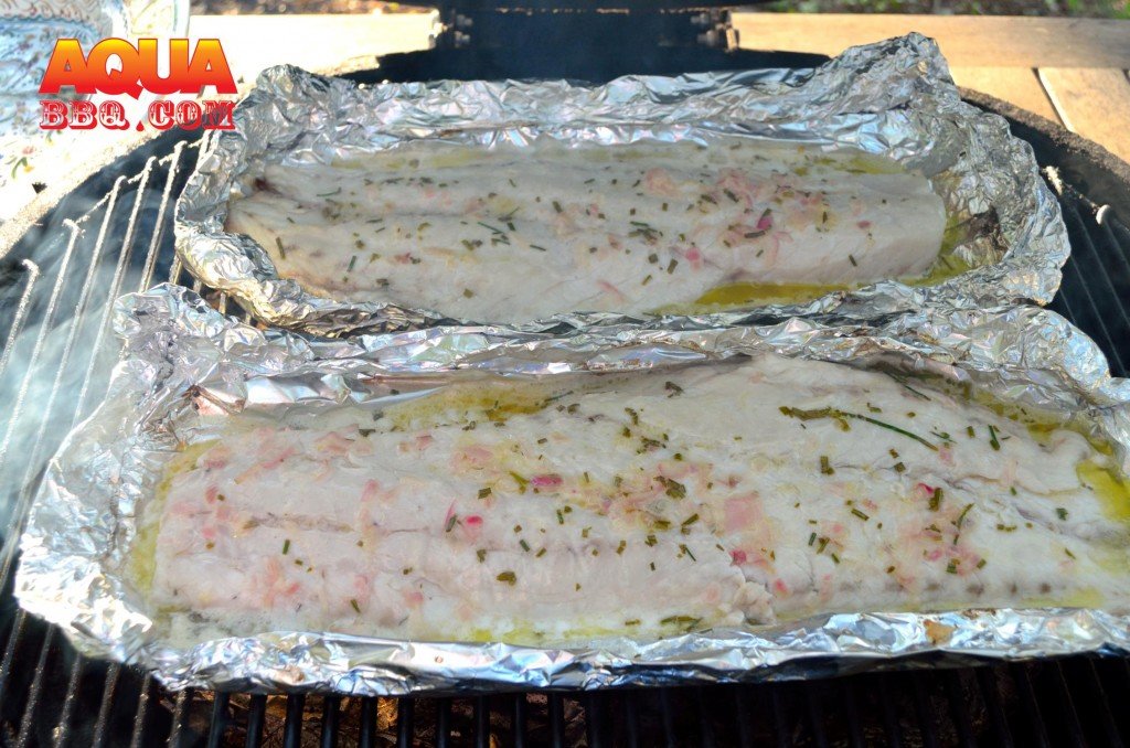 Prepare the Primo to use as a convection oven (use the ceramic deflector plates) and target a temperature of 350.  Fill each foil pan with the butter poaching liquid.