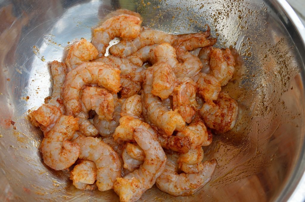 We used 2lbs of wild-caught USA jumbo shrimp that we peeled and deveined.  Coat with olive oil and your favorite rub, about 1/4 cup each, and let it rest in the fridge.  