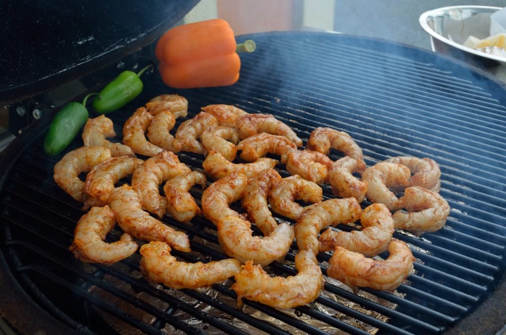 Prepare the Primo for smoking.  We recommend using only a handful of applewood chips.  You can see we put on 2 Jalapenos and an orange bell pepper to smoke along with the shrimp.