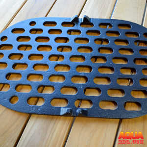 A cast iron charcoal grate on wood