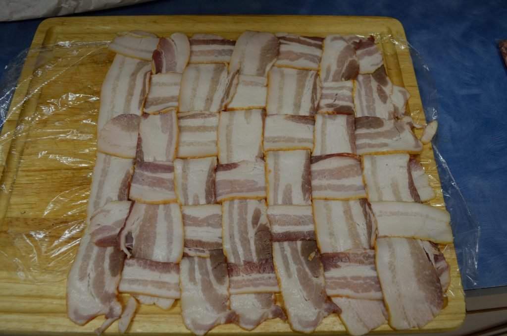 Start with your bacon weave- lay it out on plastic wrap or wax paper.  We went  7 x 7  with some bacon sourced from a local Amish market - it is longer and taller (not thick cut - you want it to cook through)