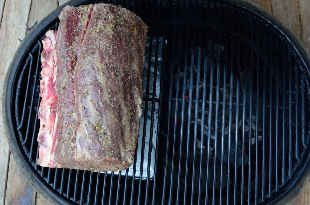 A large hunk of prime rib on a wide ceramic grill