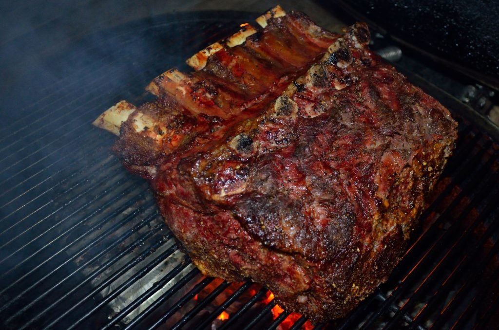 Beef prime rib on a large open grill