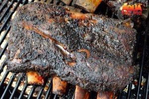 A rack of smoked beef rib on a grill