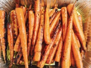 Grilled carrots in an aluminum container