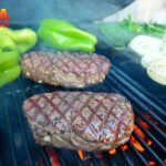 Filet Mignon, peppers, onions and asparagus on a large ceramic grill