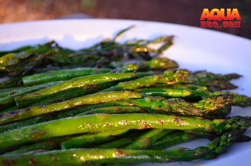Grilled asparagus on a white plate