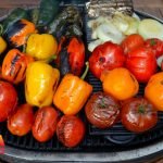 Tomatoes, Peppers, Onions and Garlic being roasted on a grill