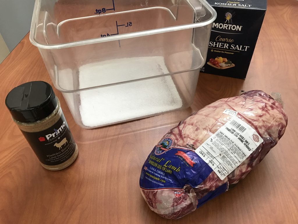 Start by brining the lamb - use a ratio of 1/2 cup of salt for every gallon of water. We also added a few tablespoons of Primo's Kleftiko Barrel Wine Rub to the brine.